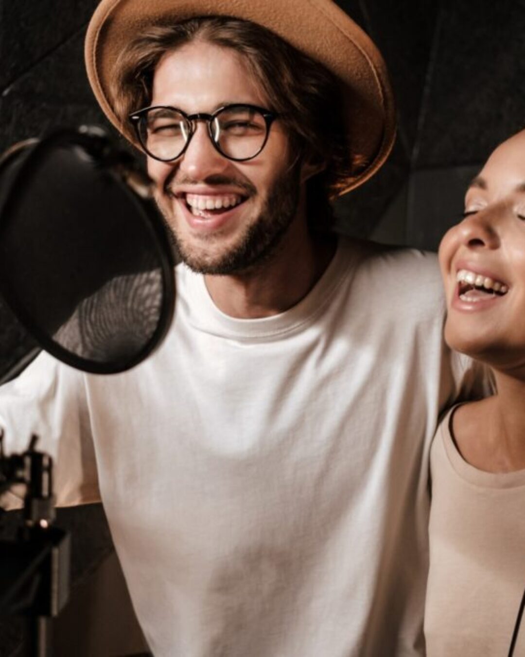 Portrait of young attractive man and woman happily singing toget